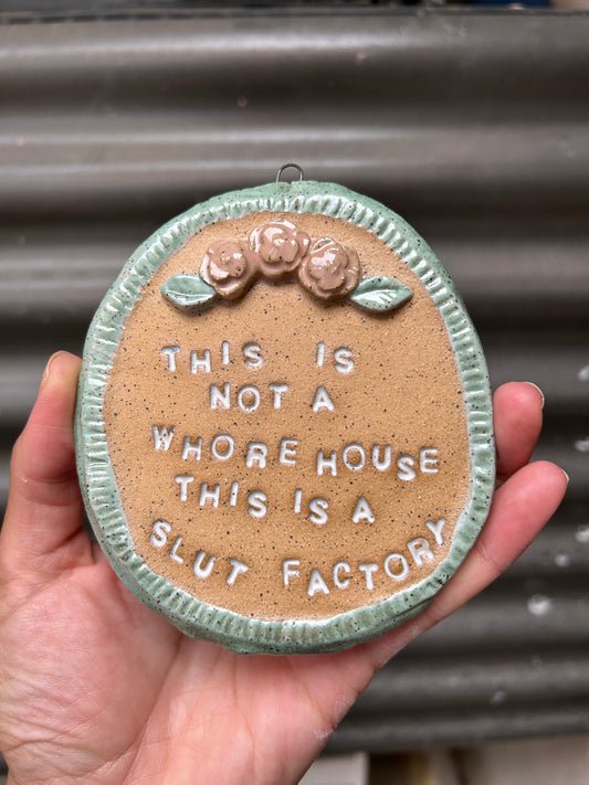 This is a Slut Factory Wall Art