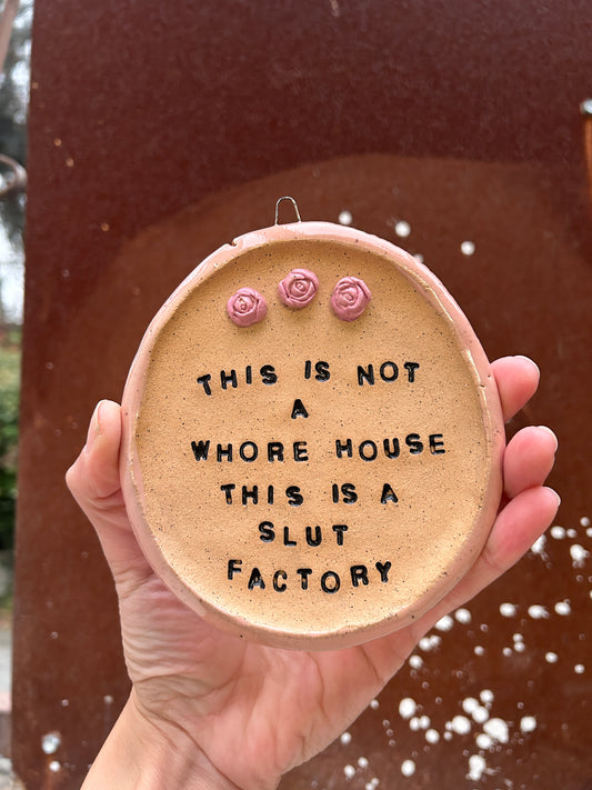 This is a Slut Factory Wall Art